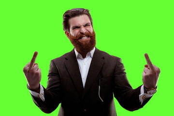 Young man wearing in suit over isolated on a green screen chrome key background. Showing middle finger fuck expression - Powered by Adobe