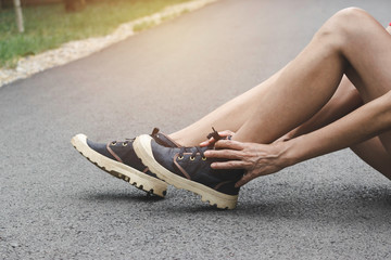 Woman walking on the road get accident on her ankle the image is for health concept.