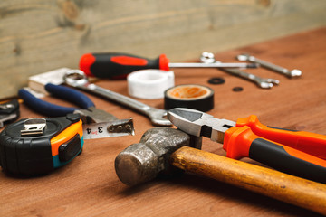 Massive hammer with other tools on a wooden table in workshop