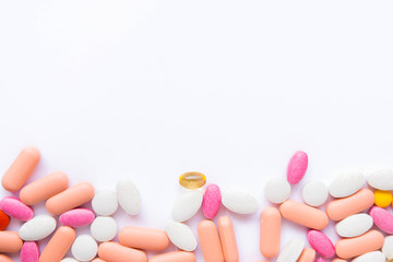 many pills and drugs in bright colors on white background