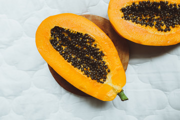 Papaya fruits with black seeds on a white background