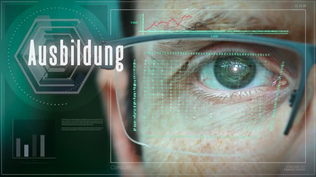 A close up of a businessman eye controlling a futuristic computer system with a Education "Ausbildung" German Business concept.
