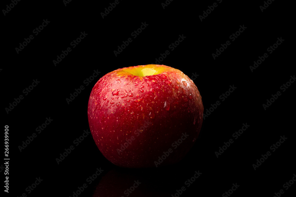 Wall mural red apple on black background