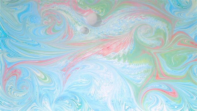 Artist creates absractive ebru design with orange, pink and white paints