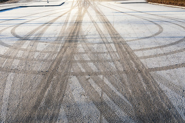 Tyre track on parking lot at winter © Juhku