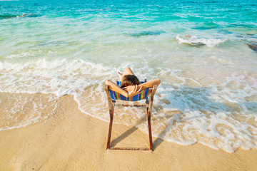 Woman enjoying beach relaxing joyful in summer by tropical sea beach