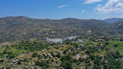 Fototapeta na wymiar Aerial drone photo of Lunar landscape with big round granite stones a unique geological phenomenon in Volax village, Tinos island, Cyclades, Greece