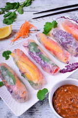 Fresh spring rolls with pepper, red cabbage, carrot and other vegetables. Vietnamese cuisine meal
