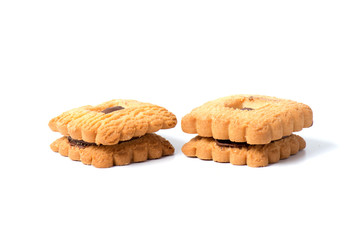 Peanut butter cookie on a white background. Golden homemade biscuit with a missing bite and trail of crumbs.