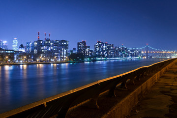 Queensboro Bridge and Queens skyline by the East River, at night, New York City, USA