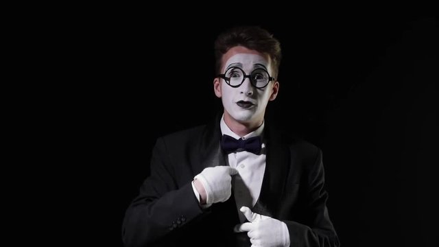mime shows gesture see nothing hear nothing say nothing on black background