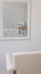 White hairdressing chair in front of the mirror 