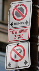 Obraz premium No parking, tow away zone. Parking restricted sign in Canada