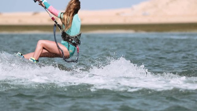 Rear View of Kitesurfer Female in Slow Motion