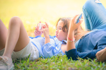 Fototapeta premium Kid relaxing in garden at sunset. Concept relax and love.