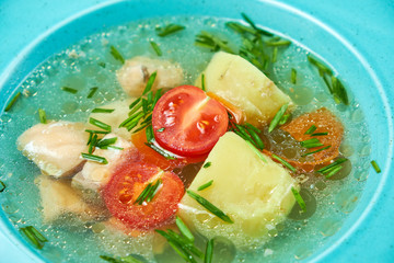 Red fish soup in a blue plate. Beautiful serving dishes. Restaurant menu