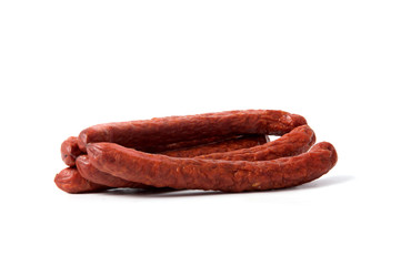 Small smoked sausages isolated on a white background.