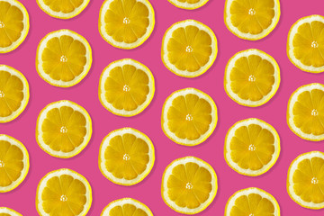 Creative pattern made of lemon. top view of fruit fresh limes slices on pink colorful background. 