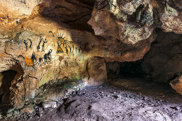 Drawing of an ancient Stone Age man in a cave. Prehistoric painting. 