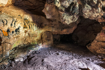Drawing of an ancient Stone Age man in a cave. Prehistoric painting. 