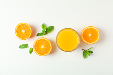 Flat lay composition with orange juice, oranges and mint on white background, space for text. Citrus drink and fruits