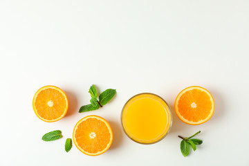 Flat lay composition with orange juice, oranges and mint on white background, space for text. Citrus drink and fruits