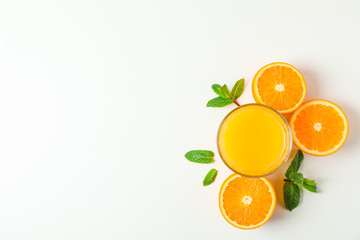 Flat lay composition with orange juice, oranges and mint on white background, space for text. Citrus drink and fruits