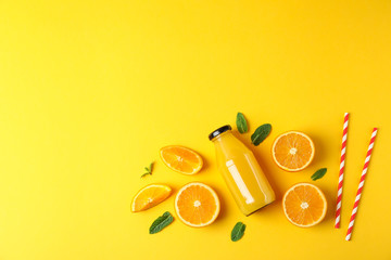 Flat lay composition with oranges, tubules and orange juice in bottle, space for text. Fresh natural drink