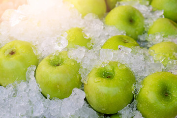 Green apple on ice at the market.