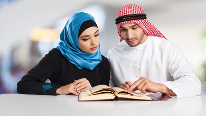 Portrait of arab couple with laptop on  background