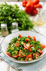 Healthy tomato salad with cucmbers, dill, onion and parsley