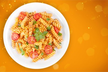 Pasta fusilli with bolognese tomato beef sauce on the kitchen table