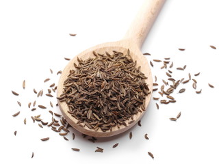 Pile of cumin seeds in wooden spoon isolated on white background