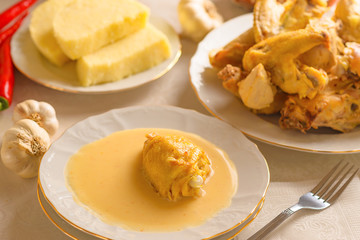 Caucasian cuisine. Circassian (Adyghe) traditional folk dish. Boiled chicken with sour cream sauce (djedlibje) Served with pasta (millet dish)