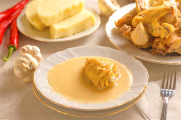 Caucasian cuisine. Circassian (Adyghe) traditional folk dish. Boiled chicken with sour cream sauce (djedlibje) Served with pasta (millet dish)