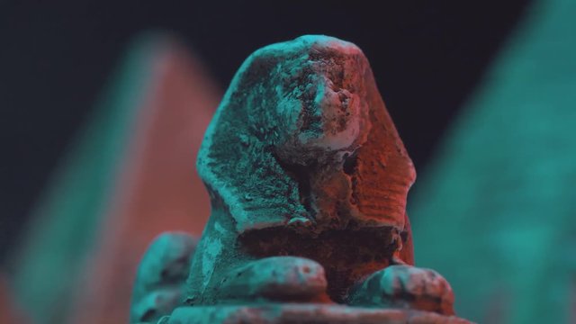 Closeup on Egyptian pyramids and a sphinx with smoke around
