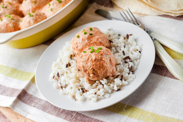 Chicken meatballs in creamy tomato sauce with rice