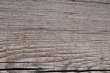 Texture photo of grey, worn, shabby, old and cracked wood which was exposed to weather and sun for years. Ideal as a background