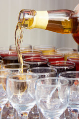 rows of glasses of wine and someone serving different port wines