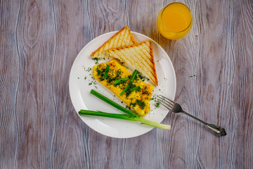 Omelet with dill and green onions on a white plate