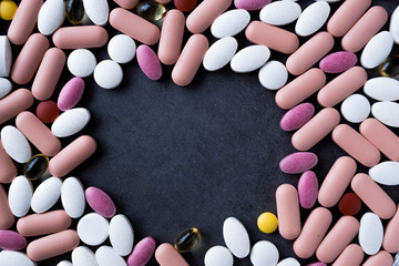 supplement pills on black background with empty space to write on