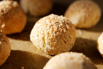 Close-up of a baked bun with side solar lighting. Fresh cottage cheese bread for healthy eating at home recipe