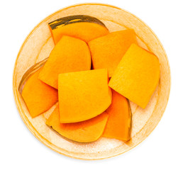 Plate with pieces of fresh pumpkin isolated on white background. Top view.