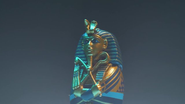 Dramatic shot of a pharaoh figure appearing in smoke.