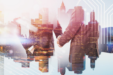 Men shaking hands in city, technology interface