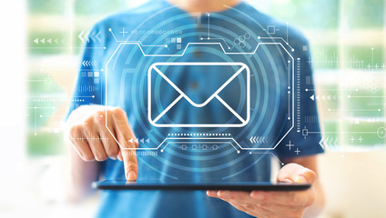 Email with young man using a tablet computer
