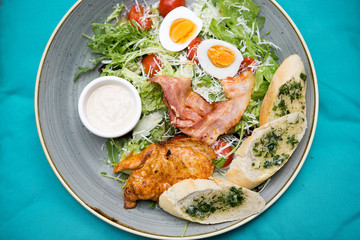 Chicken ceasar salad. Chicken, pancetta, eggs, tomatoes with garlic bread with caesar sauce. 