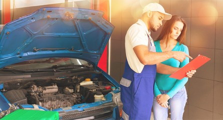 Auto mechanic and female customer in garage