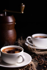 two cups of coffee on a dark background