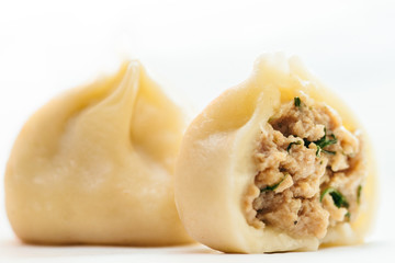 dumpling cut in half. Meat stuffing with herbs and spices inside the dumpling